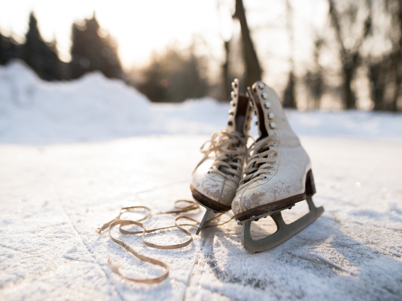 pair of ice skates sitting on an outdoor ice skating rink